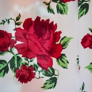 White dress with red rose embroidery.